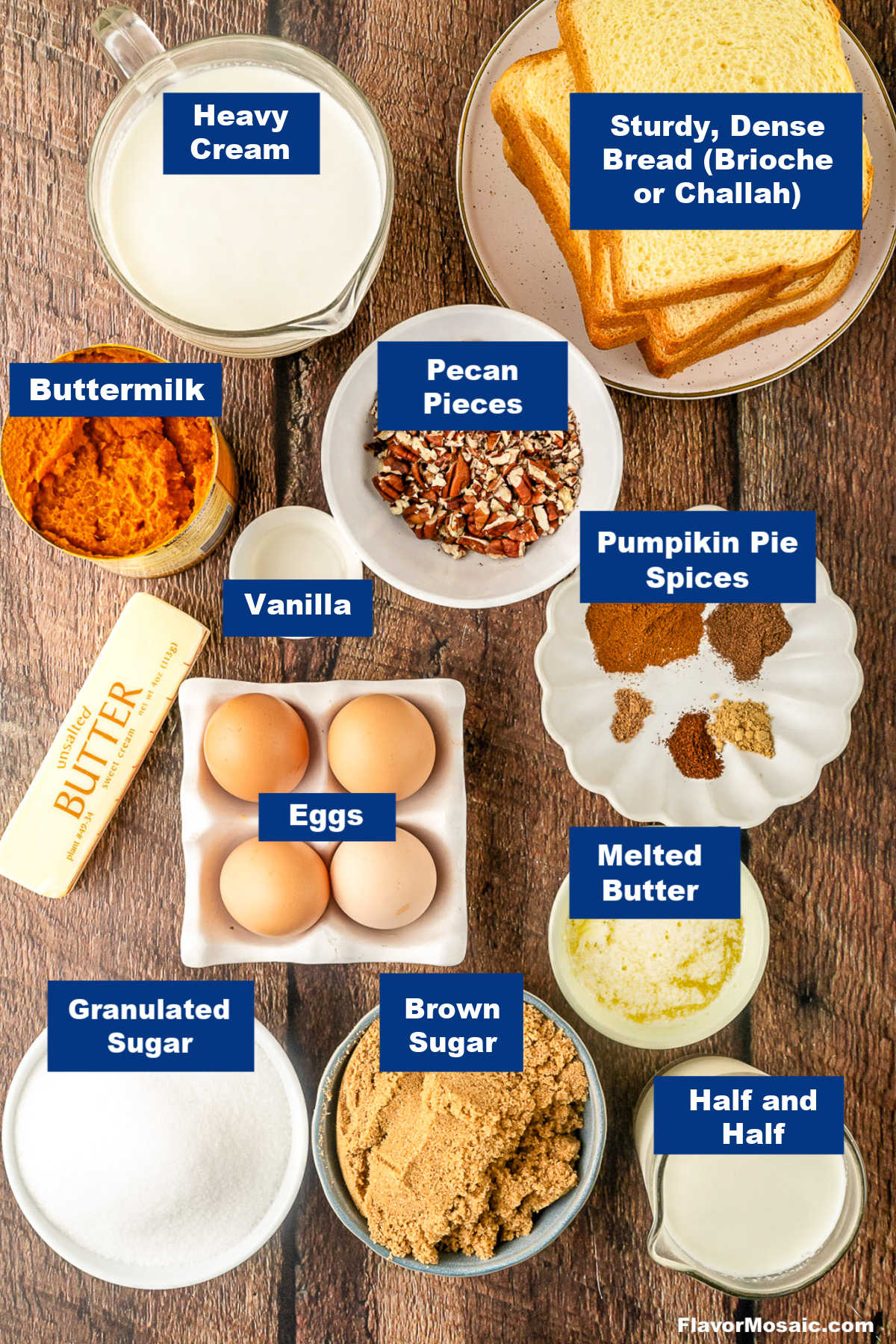Ingredients for Pumpkin Praline Bread Pudding are arranged on a table, including cream, bread, buttermilk, butter, eggs, sugar, brown sugar, half and half, vanilla, pecan pieces, and pumpkin pie spices.