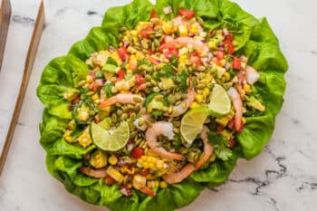 Overhead view of Mexican Shrimp Salad with all ingredients on a Bibb-lettuce covered platter.