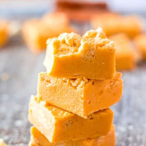 a stack of 4 pieces of pumpkin oreo fudge