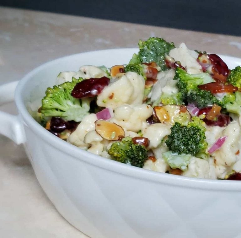 broccoli cauliflower salad in a white bowl.