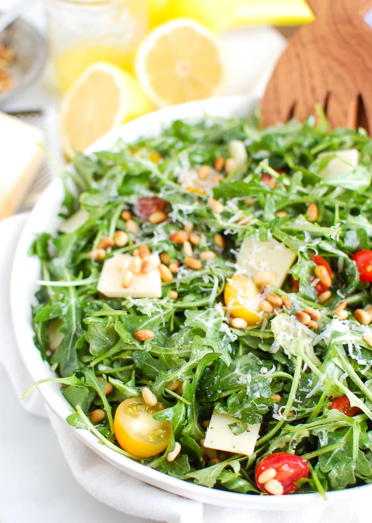 Lemon arugula salad in a white bowl.