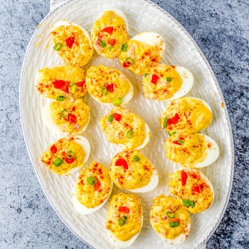 Overhead view white platter pimento Cheese Deviled Eggs.