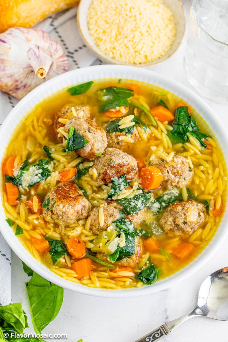 Overhead view of a white bowl of Italian Wedding Soup