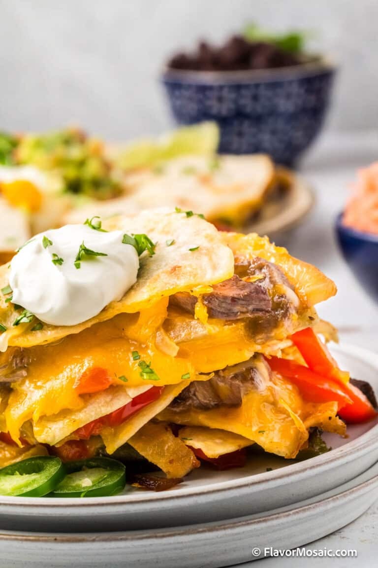 Steak Quesadillas stacked on top of one another on a plate.