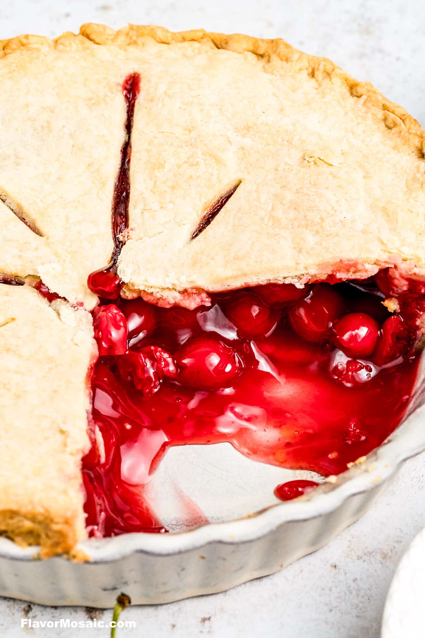 A whole pie with 2 slices taken out so you can see the filling and the top pie crust.