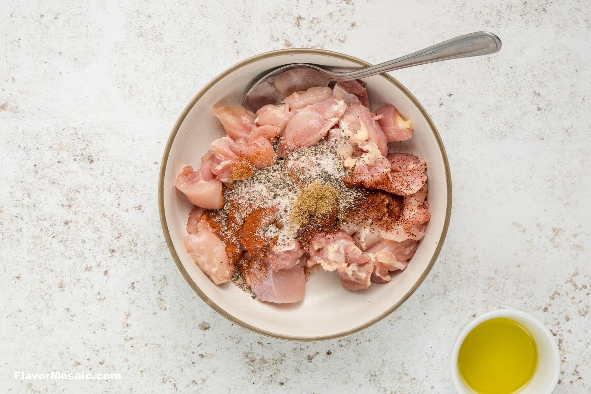 Season chicken in a bowl.