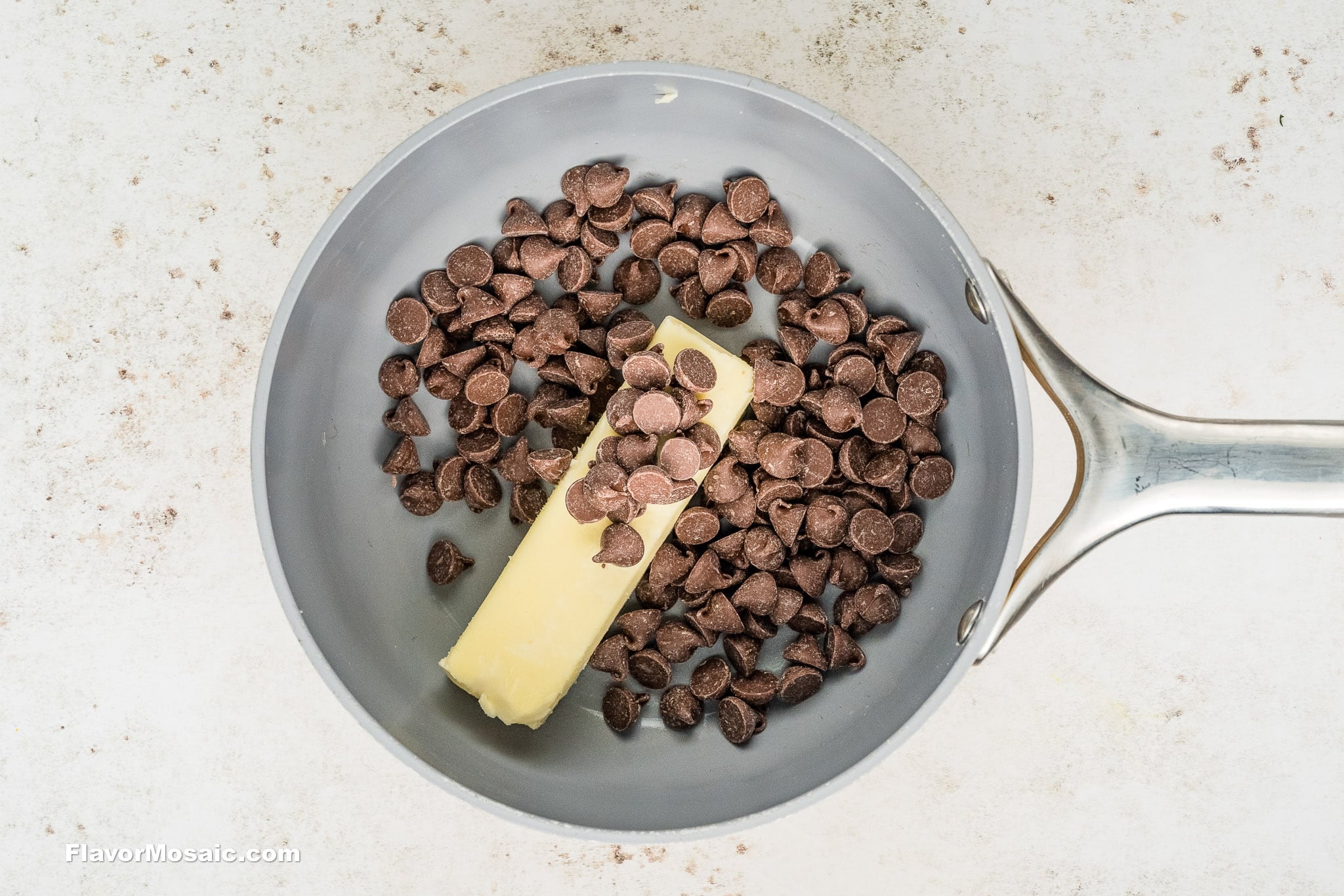 STEP 2 of How to Make Chocolate Chess Pie.  Overhead view of chocolate chips and butter.