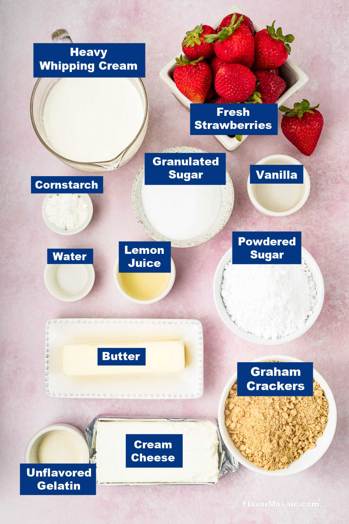 A flat lay of Strawberry Cheesecake Bars ingredients labeled: heavy whipping cream, fresh strawberries, cornstarch, granulated sugar, vanilla, water, lemon juice, powdered sugar, butter, graham crackers, cream cheese, and unflavored gelatin.